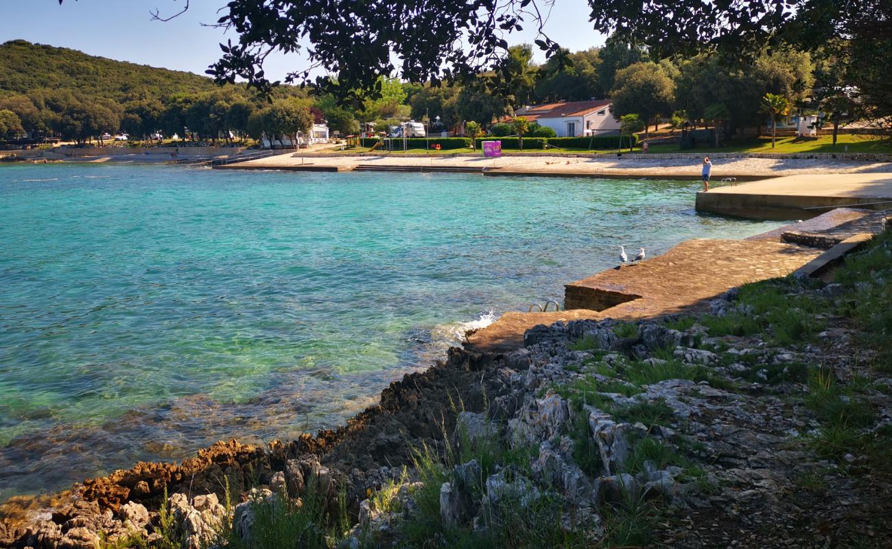 Photo de Porto Sole beach avec béton de surface