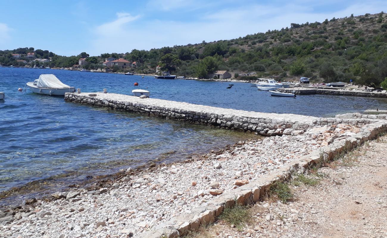 Photo de Porto Rosso beach avec caillou fin clair de surface