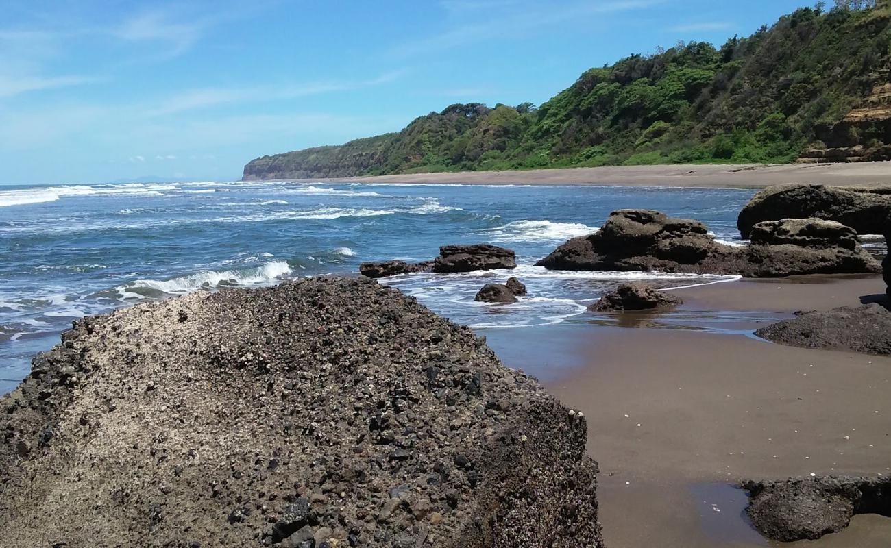 Photo de Ocosme beach avec sable brun de surface