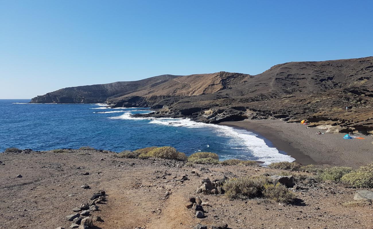 Photo de Playa Escondida avec sable brun de surface