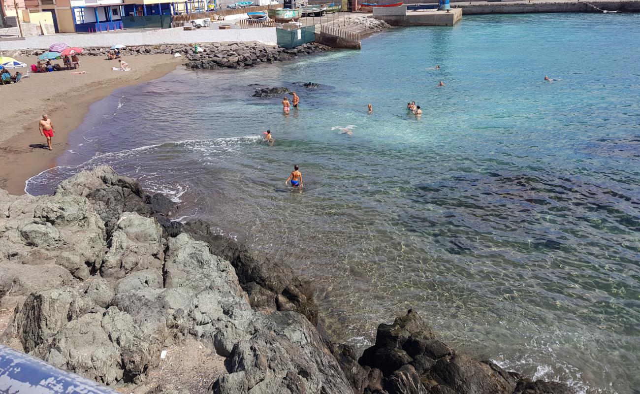 Photo de Playa del Muelle avec sable brun de surface