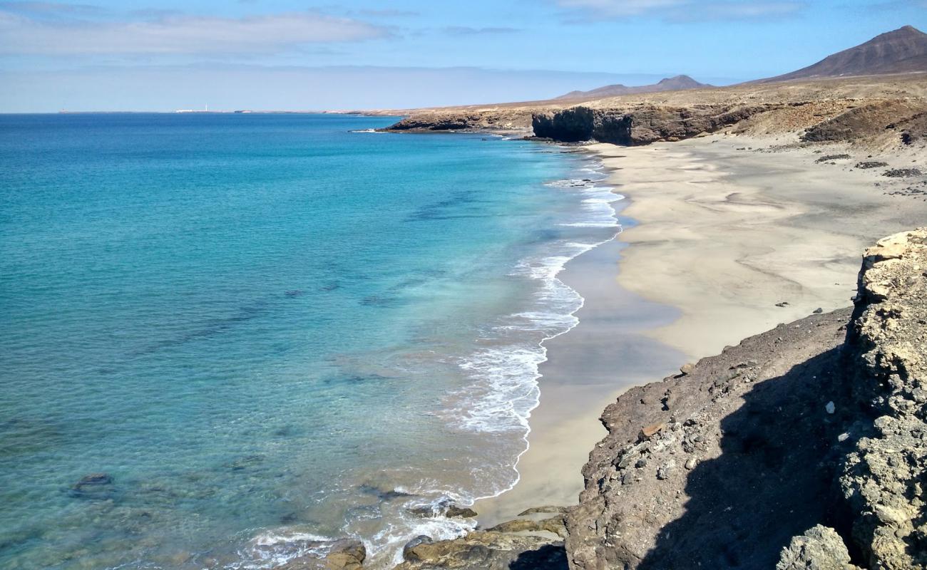 Photo de Playa Juan Gomez avec sable fin et lumineux de surface